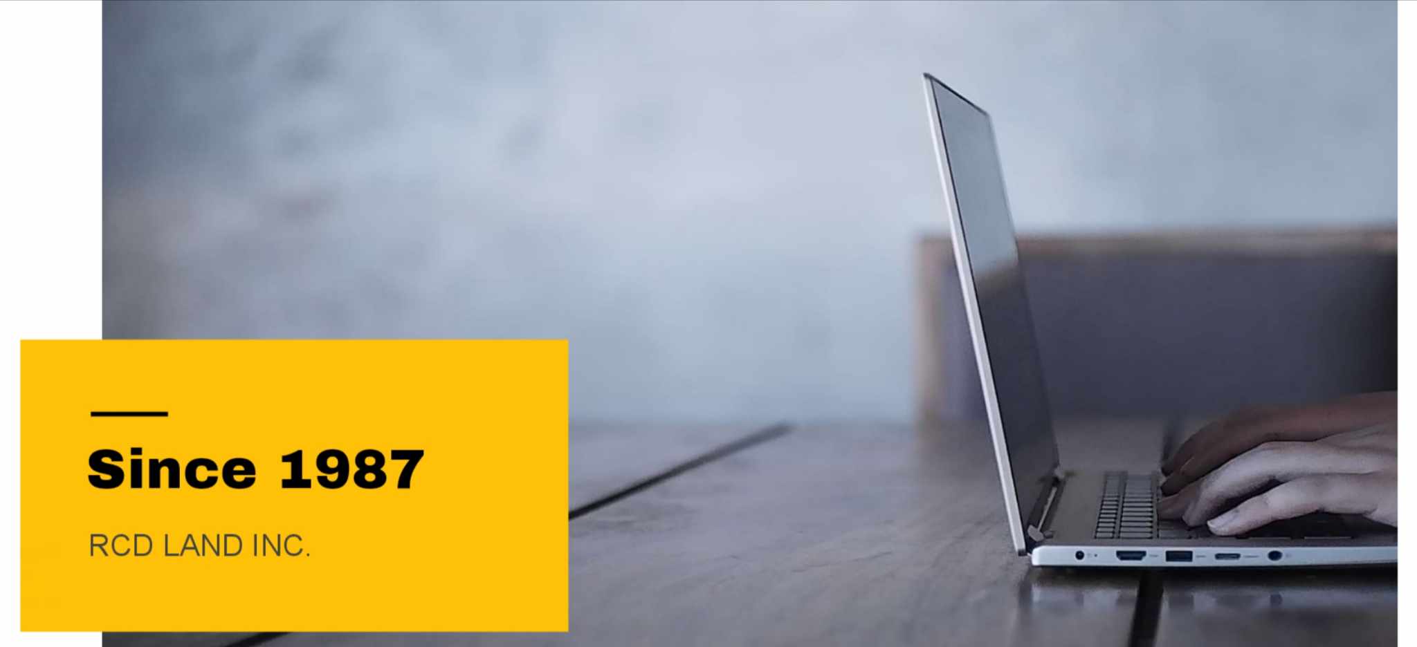 Two people, a man and a woman, looking at blueprints on a table in an office environment with natural light